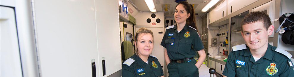 Paramedic Practice Students posing in an ambulance