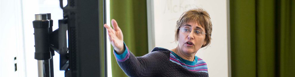 Digital design lecturer pointing towards a screen