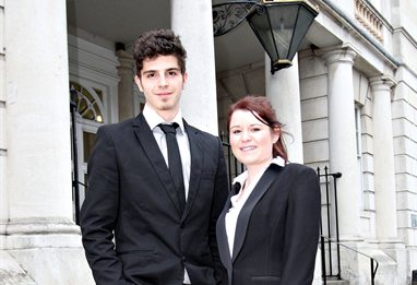Two people in black suits