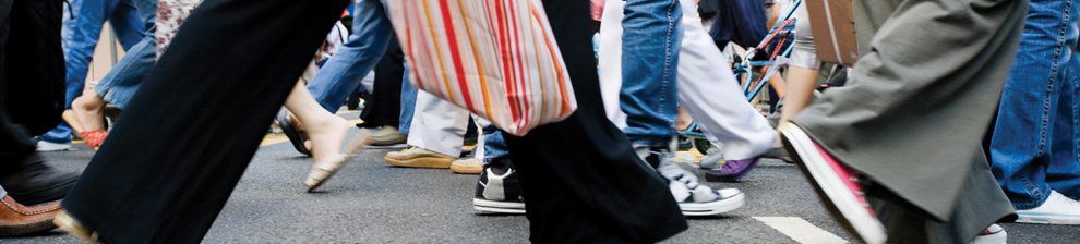 Image of people's legs walking in the street