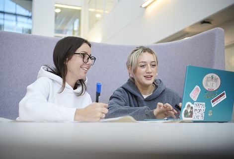 Students looking at laptop