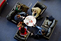 New students on sofas around a circular table