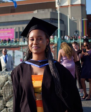 Graduate in a gown on the seafront