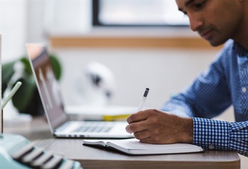 A student at a desk writing