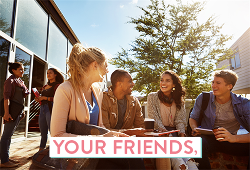A group of four students sat outside a university building