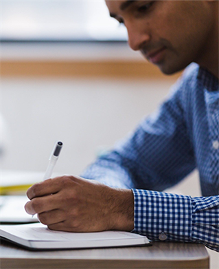 a man at a desk writing