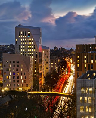 University of Brighton buildings and bridge over Lewes road at night.