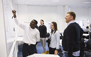 Business students in front of a whiteboard