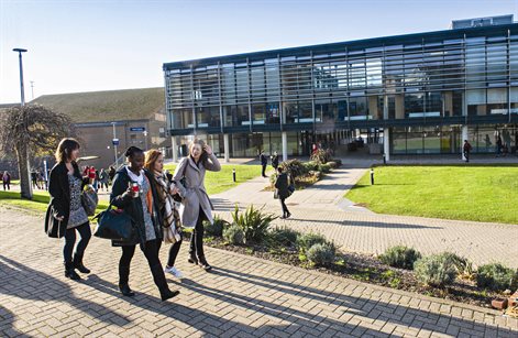 Students walking outside University of Brighton Checkland Building
