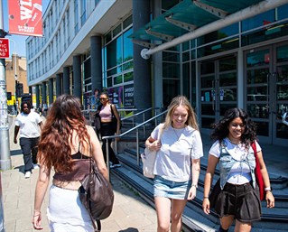 A group of students walking by the entrance of Grand Parade