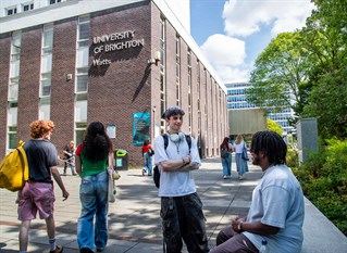 Two students chatting in front of Watts Building