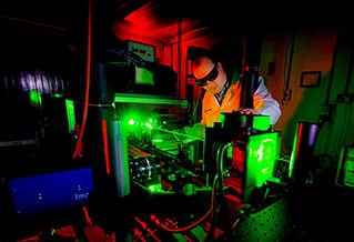 Researcher working with lasers in the Advanced Engineering Building