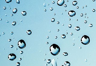 Water droplets clinging to a glass surface.