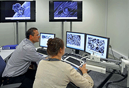 Two researchers in front of a bank of computers