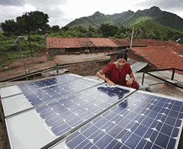Someone cleaning rooftop solar panels