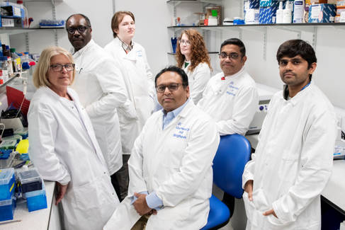 Group of researchers in white lab coats