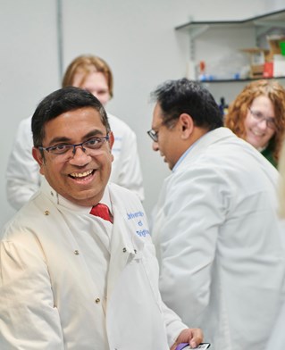 University of Brighton Genomics lab with scientists in white coats