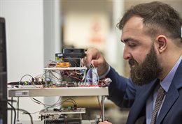 A man working with some circuit boards