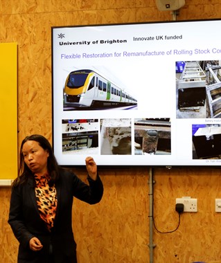 Dr Yan Wang presenting in front of a screen about remanufacturing