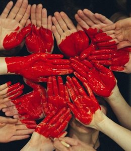 Children's health and mental health issues illustrated in putting hands together with a painted heart
