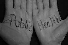 Two hands with the words 'Public Health' written on them.