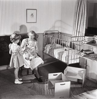 Black and white image of a child's nursery with designed bed and seats. Ideal Home Exhibition 1949. Council of Industrial Design.