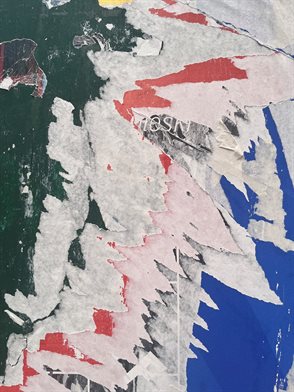 Patterns of stuck, ripped paper. Traces of wheat-pasted posters on hoardings in New York. Photograph courtesy of Alex Todd