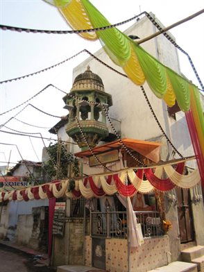 Asian temple on street corner with colourful street banners