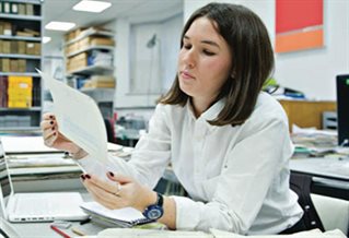 Picture of researcher making use of the collection at the University of Brighton Design Archives