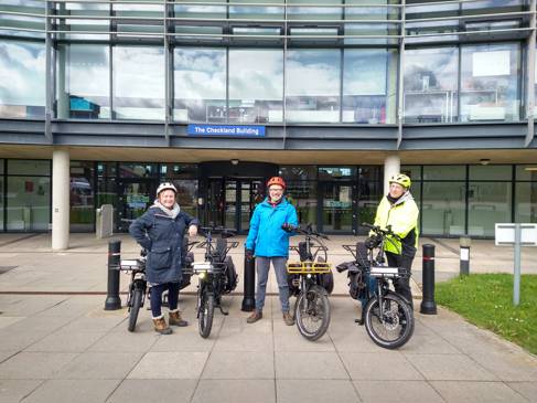 Members of staff in front of Checkland building with the e-bikes used for ELEVATE project