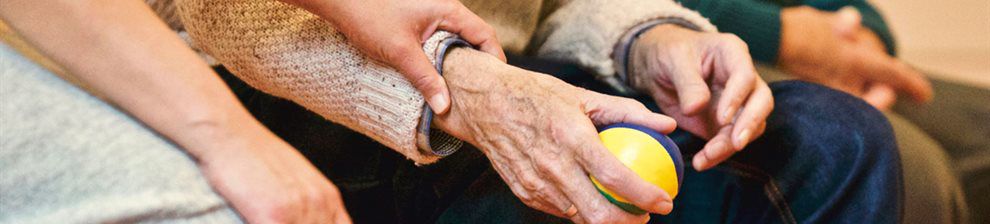 Image representing research study for psychology, shows a pair of very old hands clutching a small ball, a younger person's hands are reaching to touch the elderly wrists