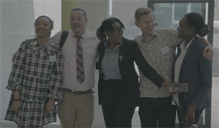 A group of doctoral PhD students posing for a group photograph at a PhD event. Students at the University of Brighton doctoral college are, as here, diverse in age, gender, ethnicity and needs.