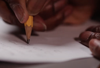 Hands of student with a pencil note-taking