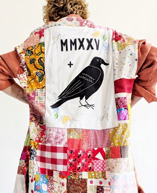 Emma Collins, PhD arts student. A coat, remade using handsewn fabric scraps sent from a community of Instagram makers from countries around the world. The applique crow embodies the sisterhood of the community. 2025