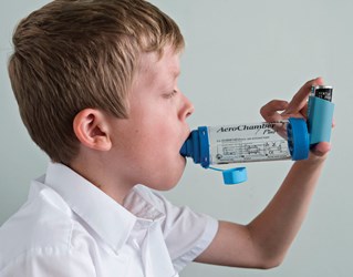 child using asthma inhaler illustrating asthma research from Brighton and Sussex Medical School