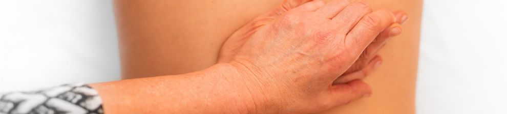 Physiotherapist's hands working in the middle of a patient's back. Courtesy Benjamin Wedemeyer and Unsplash