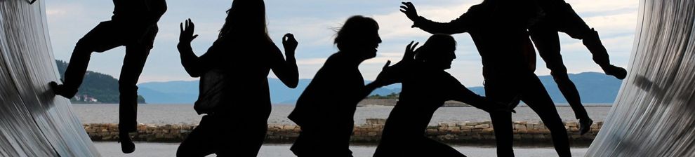 Silhouette of six adults playing at the mouth of a tunnel with the sea in the distance. Courtesy Maike und Björn Bröskamp from Pixabay