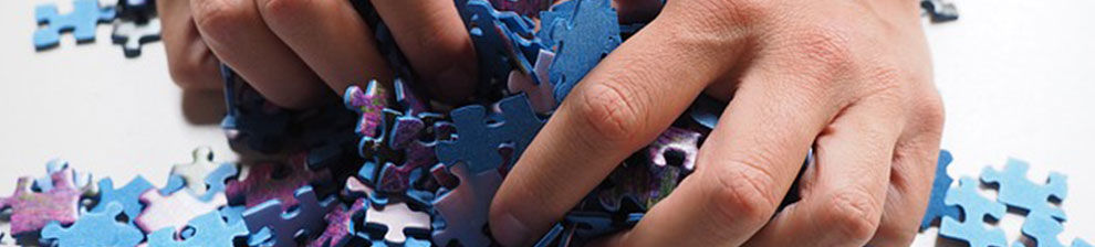 Hand grabbing jigsaw pieces