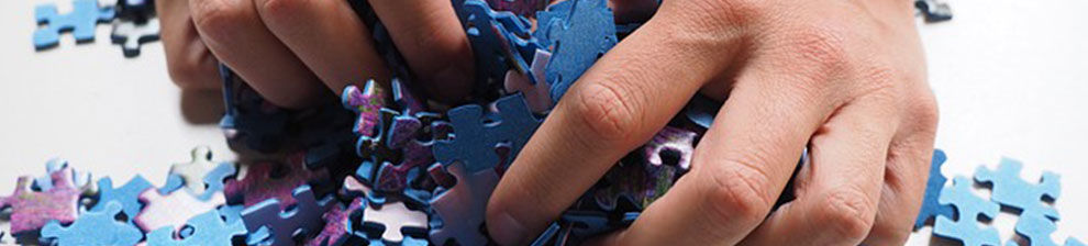 Hand grabbing jigsaw pieces