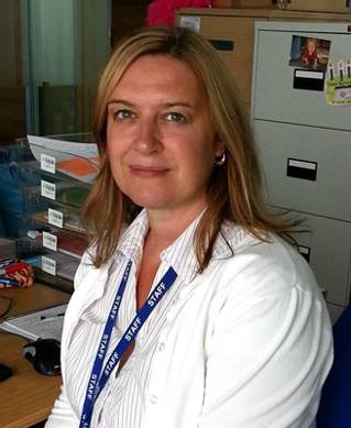 Dr Melanie Flint sitting at her desk