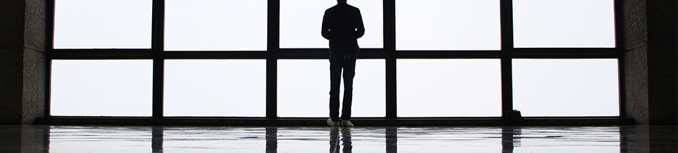 Woman standing in front of a large window