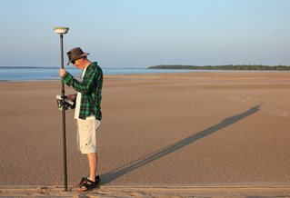 Researcher on location conducting investigation into river morphology