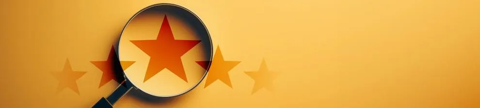 Star shown through magnifying glass on orange background