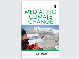 Front cover of Professor Julie Doyle's book Mediating Climate Change shows a researcher in a polar region pointing to a snowy version of the mountainous background of the landscape