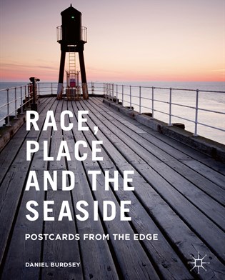 Cover of Dan Burdsey's monograph study, Race, Place and the Seaside: Postcards from the Edge. Image shows end of short wooden pier with a low sun over the horizon line of the sea.