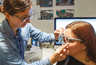 Someone having large glasses fitted for a study