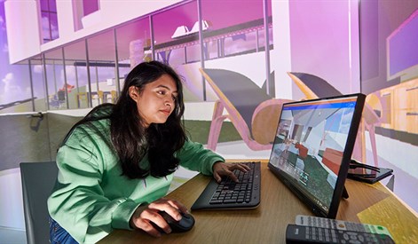 Student on computer in our igloo immersive design space