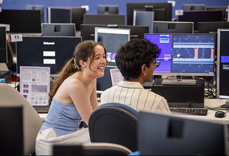 Two students at computers in a lab