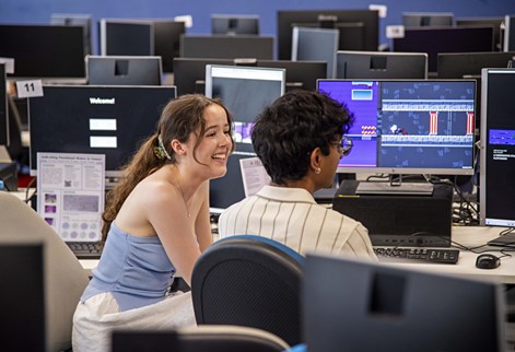 Two students at computers in a lab