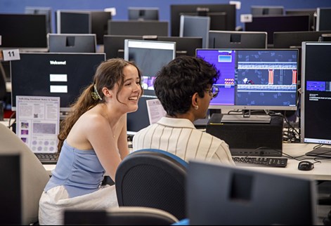 Two students at computers in a lab